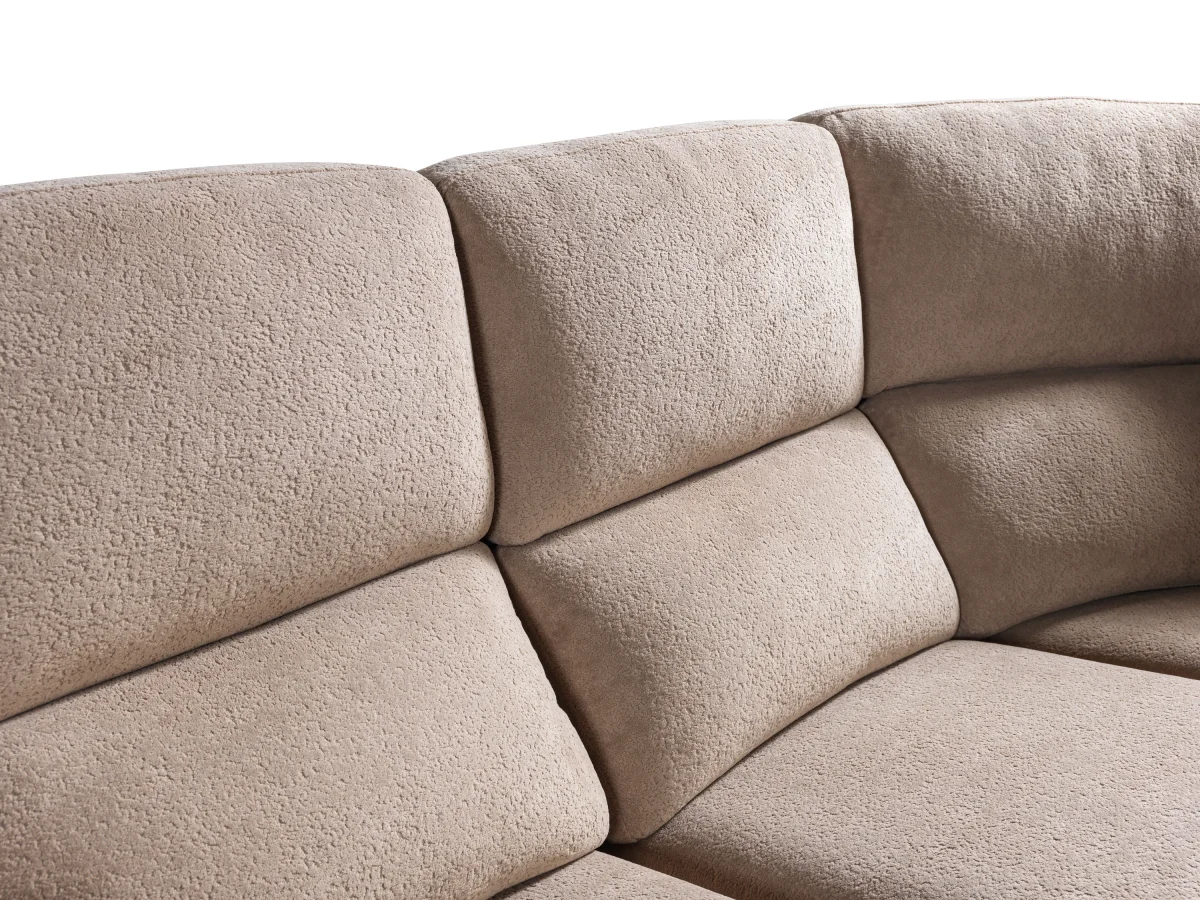 A detailed view of the Atlas Recliner Köşe Takımı, a contemporary L-shaped corner sectional sofa upholstered in textured beige fabric. The image shows its modern design with sleek lines and wide seats. The central console unit is featured, with an open lid, integrated cup holders, and a built-in Bluetooth speaker system visible on the side. The sofa is placed in a premium living room with light wood floors and textured wall paneling with LED backlighting.