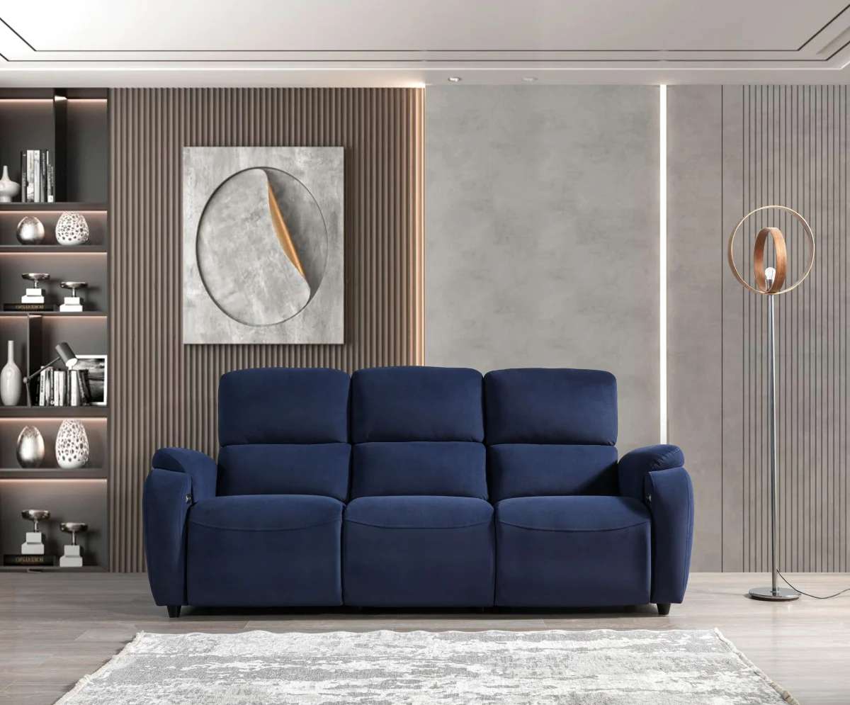 A front-facing view of the Atlas Triple, a premium cream-colored triple recliner sofa featuring vertical stitching on the plush back cushions and integrated control buttons with a USB port on the side of the armrest.