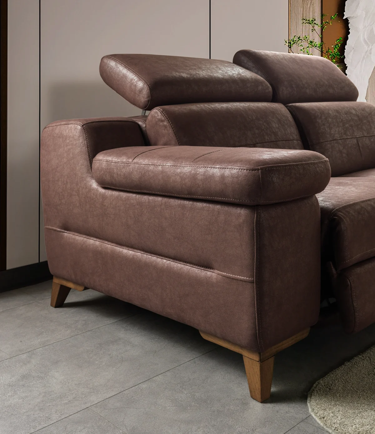 A detailed view of the Serena Motorized Triple Recliner, a premium brown three-seater sofa manufactured by Chairium, featuring extended motorized footrests and adjustable headrests on the outer seats.