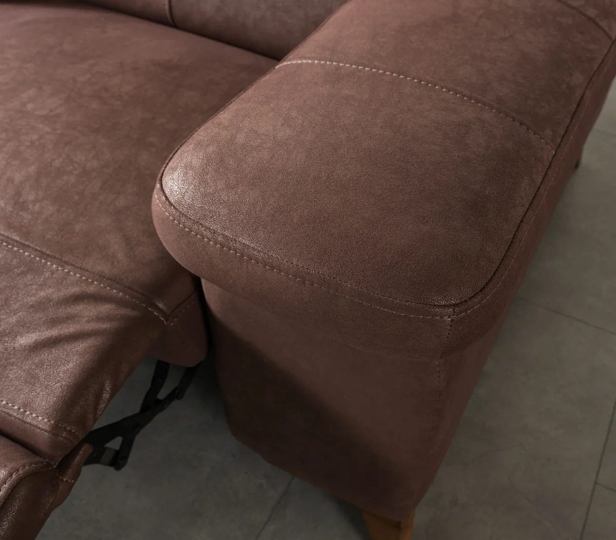 A detailed view of the Serena Motorized Double Recliner, a premium brown double sofa manufactured by Chairium, featuring extended motorized footrests and adjustable motorized headrests.
