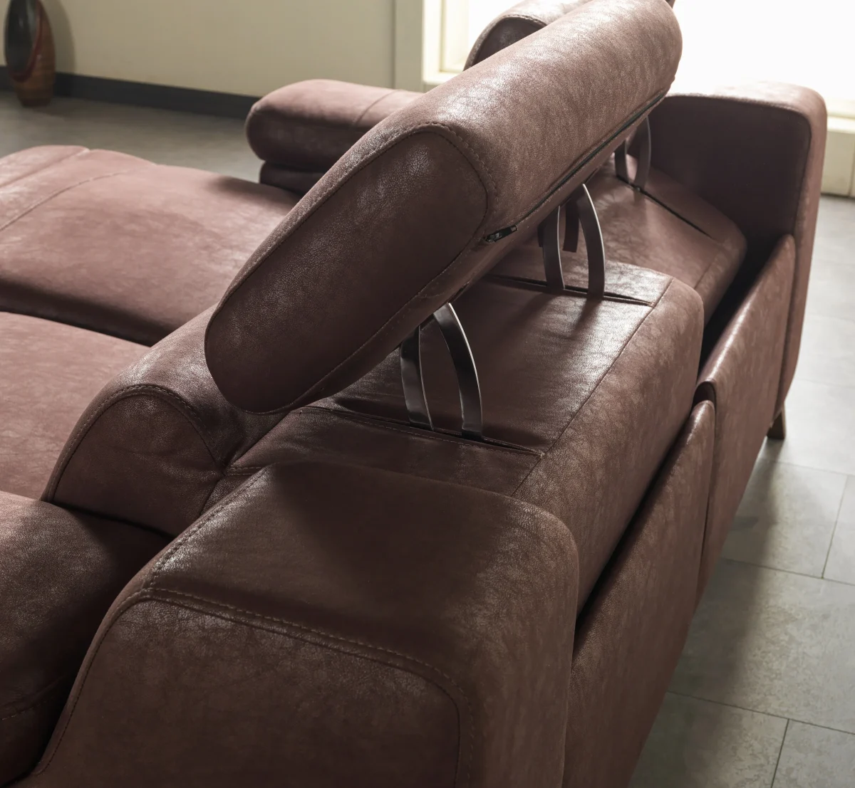 A detailed view of the Serena Motorized Double Recliner, a premium brown double sofa manufactured by Chairium, featuring extended motorized footrests and adjustable motorized headrests.
