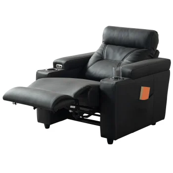 A front-facing view of the ZERO PLUS recliner, a luxurious black leather recliner chair with ergonomic stitched paneling and built-in cup holders. The recliner is centered on a light rug in a modern living room setting featuring elegant wood wall panels, accompanied by a tall woven vase holding decorative dry grass.